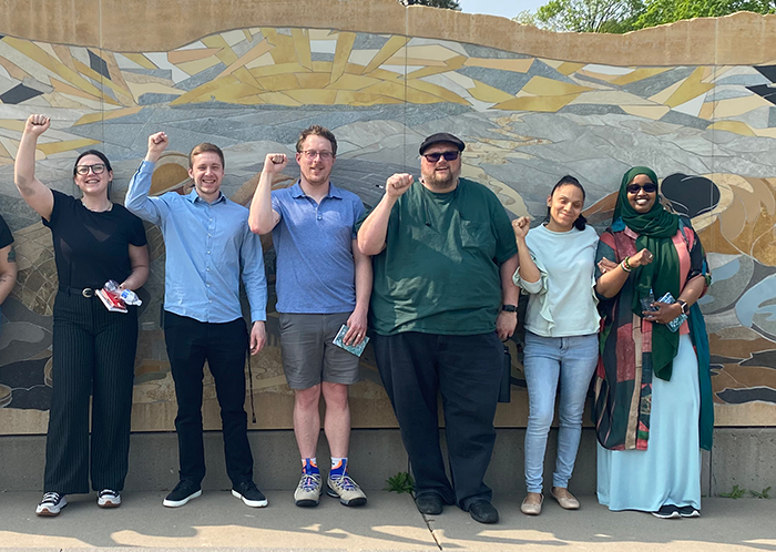 The Minnesota AFL-CIO's six new regional organizers stand in front of the Minnesota Workers Memorial