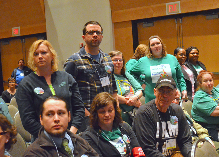 Workers who have been injured or assaulted on the job at a state mental health facility stand up during AFSCME Council 5’s Day on the Hill rally. Photo via St. Paul Union Advocate.